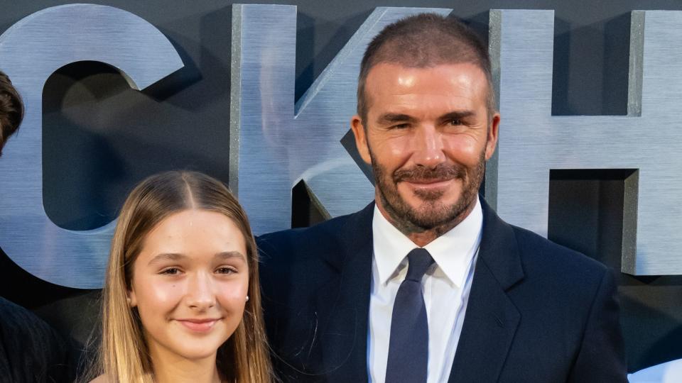 david beckham embracing his daughter harper with his right arm at a premiere event