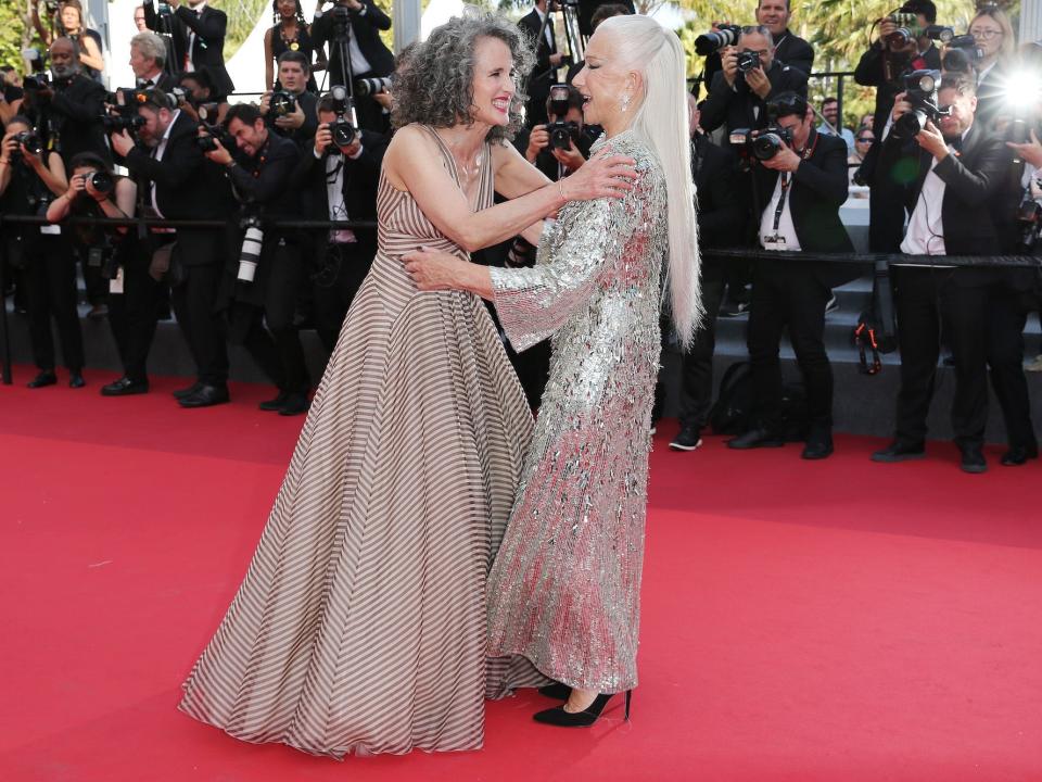 Andie MacDowell and Helen Mirren hug on the Cannes Film Festival red carpet.