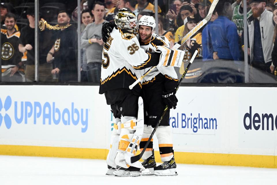BOSTON, MASSACHUSETTS - NOVEMBER 07: Goaltender Linus Ullmark #35 of the Boston Bruins hugs teammate Patrice Bergeron #37 after the Bruins defeated the St. Louis Blues 3-1 at the TD Garden on November 07, 2022 in Boston, Massachusetts. (Photo by Brian Fluharty/Getty Images)