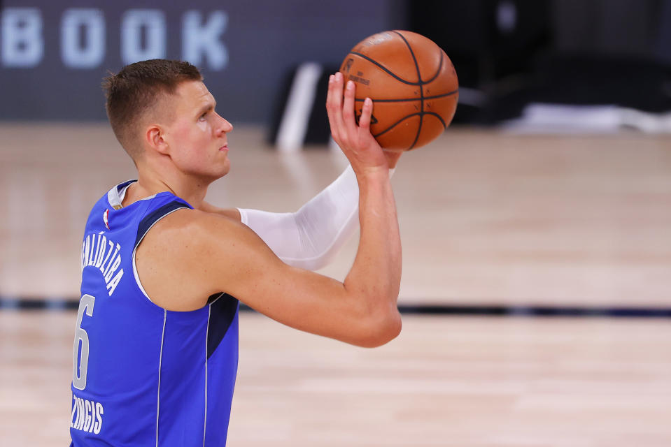 LAKE BUENA VISTA, FLORIDA - AUGUST 21: Kristaps Porzingis #6 of the Dallas Mavericks shoots a free throw against the LA Clippers during the fourth quarter in Game Three of the Western Conference First Round during the 2020 NBA Playoffs at AdventHealth Arena at ESPN Wide World Of Sports Complex on August 21, 2020 in Lake Buena Vista, Florida. NOTE TO USER: User expressly acknowledges and agrees that, by downloading and or using this photograph, User is consenting to the terms and conditions of the Getty Images License Agreement. (Photo by Mike Ehrmann/Getty Images)