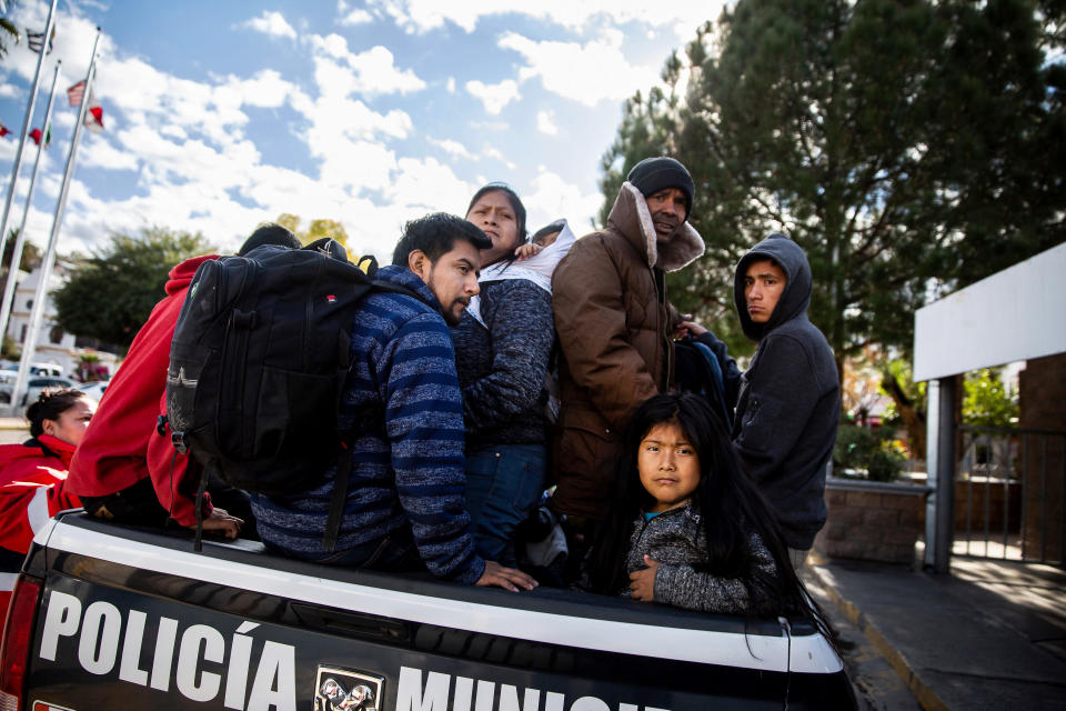 In this Thursday, Jan. 2, 2020 photo, asylum seekers sit in the back of a Mexican police vehicle after being returned to Nogales, Sonora, Mexico, after making their claims in the United States, on Jan. 2, 2020. After a recent change, asylum seekers will now wait for their court hearings in Nogales. Prior to this change people had to wait for their hearings in Ciudad Juarez. Court hearings will still be held in El Paso. (Josh Galemore/Arizona Daily Star via AP)