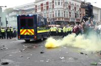 Britain Soccer Football - West Ham United v Manchester United - Barclays Premier League - Upton Park - 10/5/16 General view of a smoke bomb among police and fans before the match Reuters / Eddie Keogh Livepic EDITORIAL USE ONLY. No use with unauthorized audio, video, data, fixture lists, club/league logos or "live" services. Online in-match use limited to 45 images, no video emulation. No use in betting, games or single club/league/player publications. Please contact your account representative for further details.