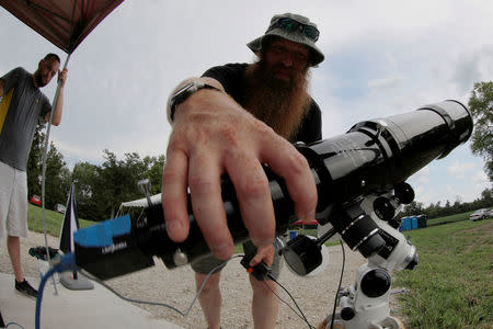 Members of the Citizen CATE (Continental America Telescopic Eclipse) experiment, a nationwide effort collecting images of the total eclipse and the sun's corona, prepare at their "dark" site in Carbondale, Illinois, U.S., August 20, 2017, one day before a total solar eclipse in the city. REUTERS/Brian Snyder