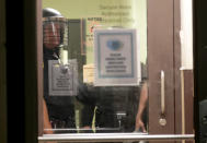 Aug 23, 2020; Kenosha, WI, USA; Kenosha police look out from inside the Kenosha Police Department as protesters gather outside in Kenosha on Sunday, Aug. 23, 2020. Kenosha police shot a man Sunday evening, setting off unrest in the city after a video appeared to show the officer firing several shots at close range into the man's back.Mandatory Credit: Mike De Sisti/Milwaukee Journal Sentinel via USA TODAY NETWORK/Sipa USA