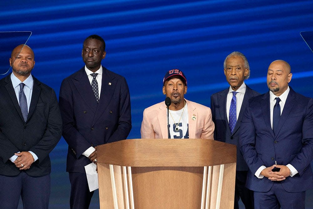 Korey Wise, a member of “the Central Park Five,” stands with Kevin Richardson, far left, New York City Councilman Yusef Salaam, Rev. Al Sharpton and Raymond Santana during the final day of the Democratic National Convention at the United Center.