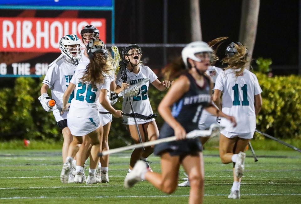 Gulf Coast Sharks players celebrate after defeating the Sarasota Riverview Rams in the Class 2A regional quarterfinal game at Gulf Coast High School in Naples on Tuesday, April 18, 2023.