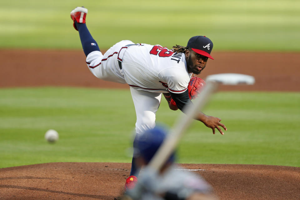 Atlanta Braves relief pitcher Touki Toussaint, top, delivers to New York Mets' Jeff McNeil in the first inning of a baseball game Saturday, Aug. 1, 2020, in Atlanta. (AP Photo/John Bazemore)