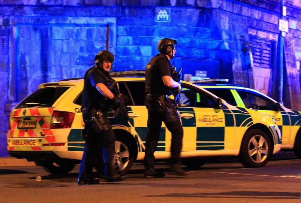 Explosion: Armed police at Manchester Arena after reports of an explosion at the venue during an Ariana Grande gig (Peter Byrne/PA Wire)