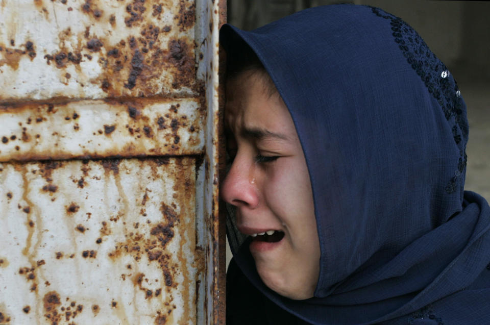 FILE - A Palestinian woman from the El Deeb family, who had ten relatives killed near a United Nations school Tuesday, weeps during their funeral in the Jebaliya refugee camp, in the northern Gaza Strip, Wednesday, Jan. 7, 2009. Israel's military paused its Gaza offensive for three hours Wednesday to allow food and fuel to reach besieged Palestinians, and the country's leaders debated whether to accept an international cease-fire plan or expand the assault against Hamas. (AP Photo/Hatem Moussa, File)