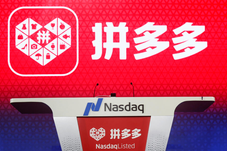 The logo of online group discounter Pinduoduo is seen on a stage before the company's stock trading debut at the Nasdaq Stock Market in New York, during an event in Shanghai, China July 26, 2018. Picture taken July 26, 2018.  REUTERS/Stringer ATTENTION EDITORS - THIS IMAGE WAS PROVIDED BY A THIRD PARTY. CHINA OUT.