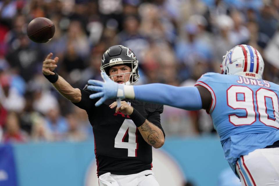 Atlanta Falcons quarterback Taylor Heinicke (4) throws under pressure from Tennessee Titans defensive tackle Naquan Jones (90) during the second half of an NFL football game, Sunday, Oct. 29, 2023, in Nashville, Tenn. (AP Photo/George Walker IV)