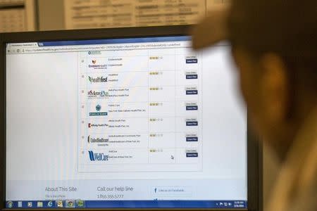 Josiah Diamond looks at health care plan options on a government health site while trying to enroll in a plan at the Community Service Society in New York, March 31, 2014. REUTERS/Brendan McDermid