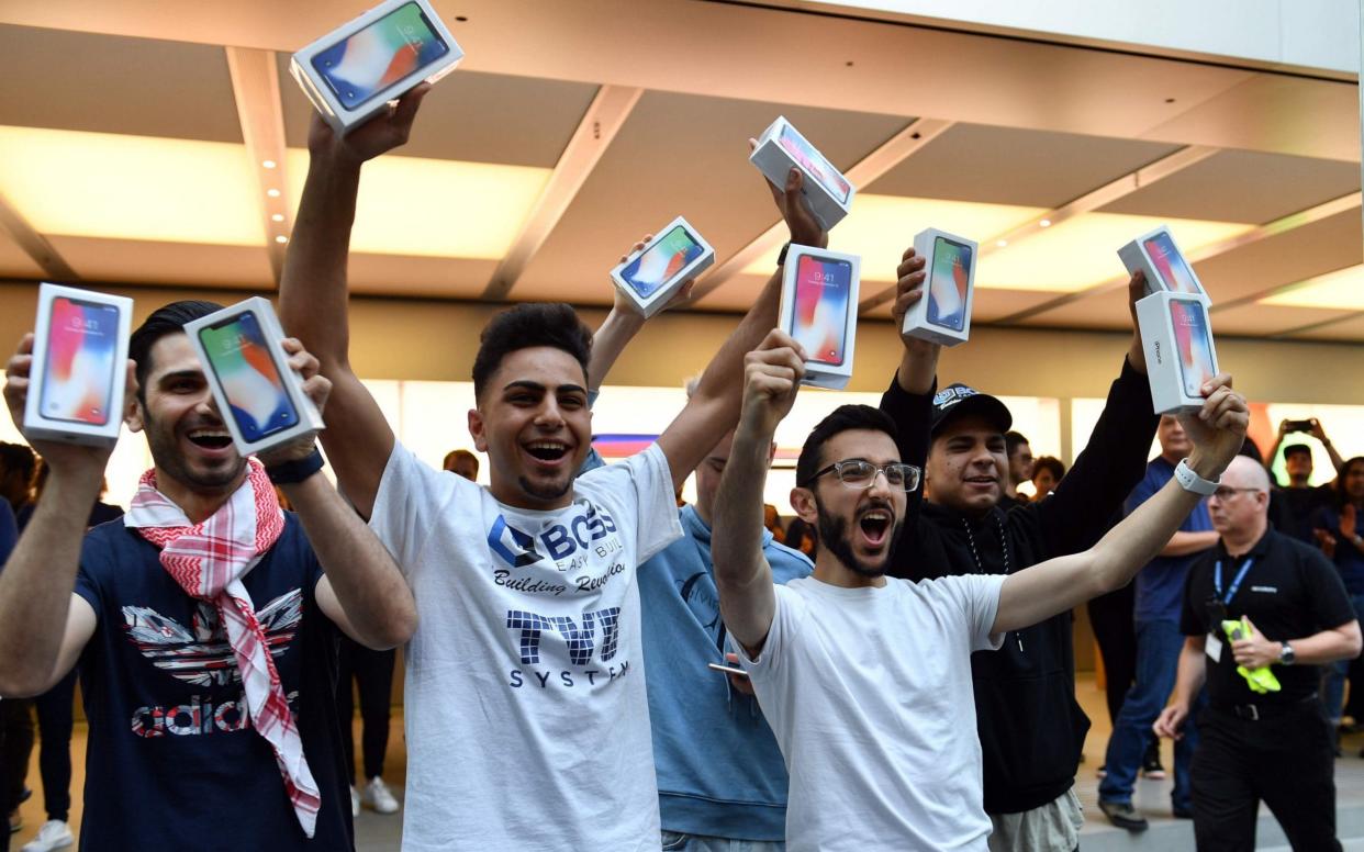 Shoppers with the iPhone X - AFP