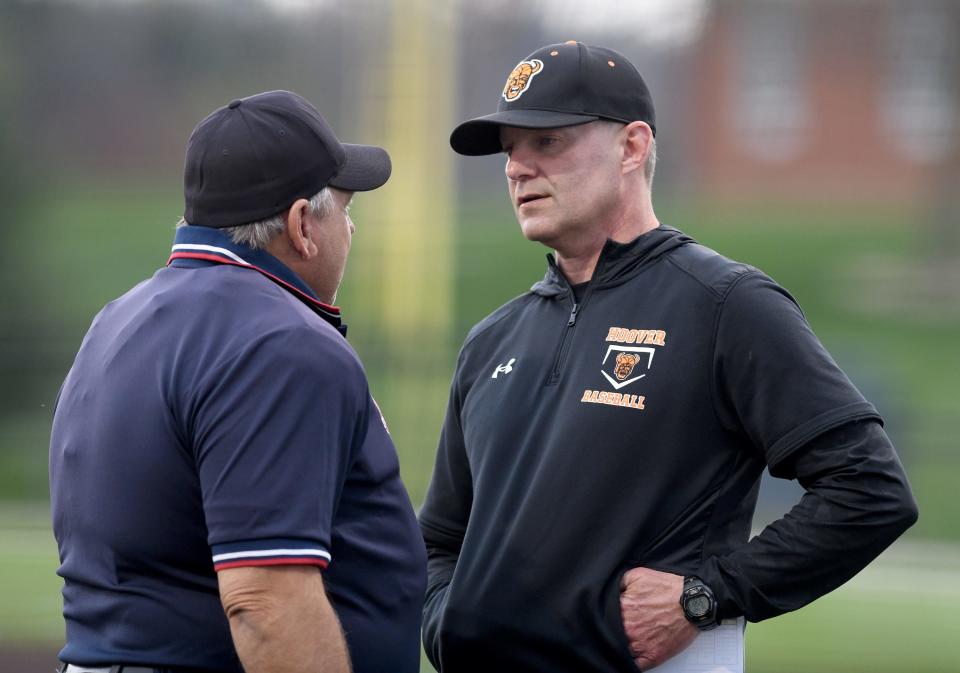 Hoover baseball coach Bryan Ashby talks to an umpire during a lighting delay in the fifth inning on April 9.