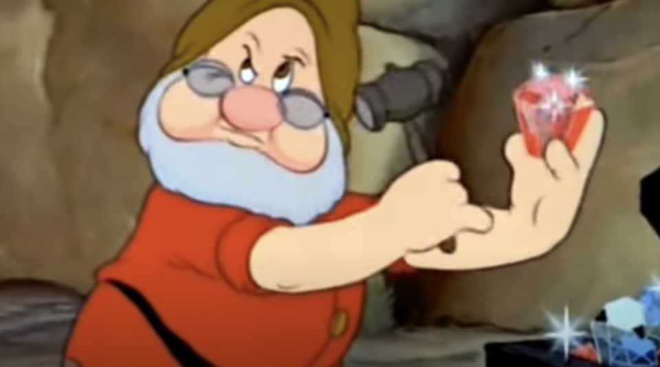 one of the dwarfs examining a gem