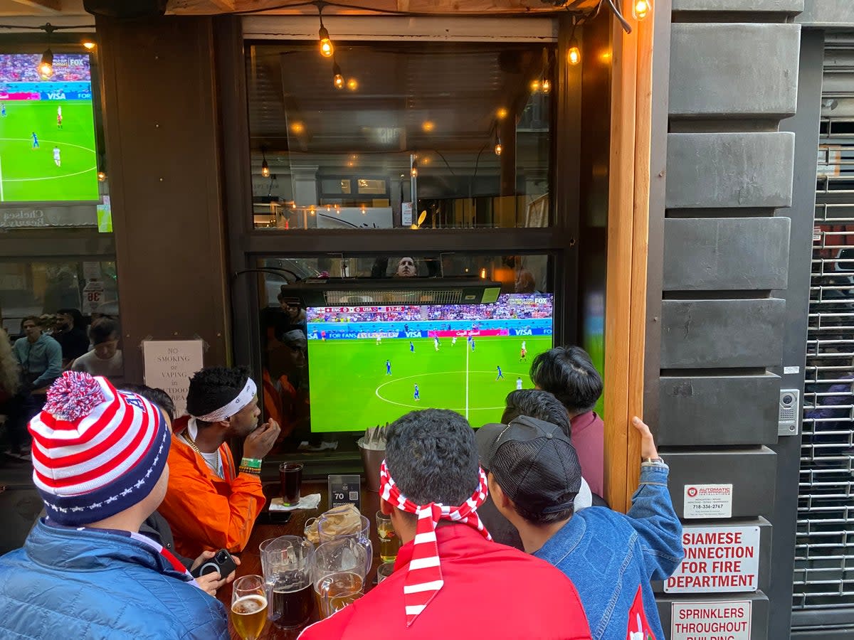 Football fans watch England vs USA at a New York bar in the group stage of the 2022 World Cup.  (Richard Hall / The Independent )