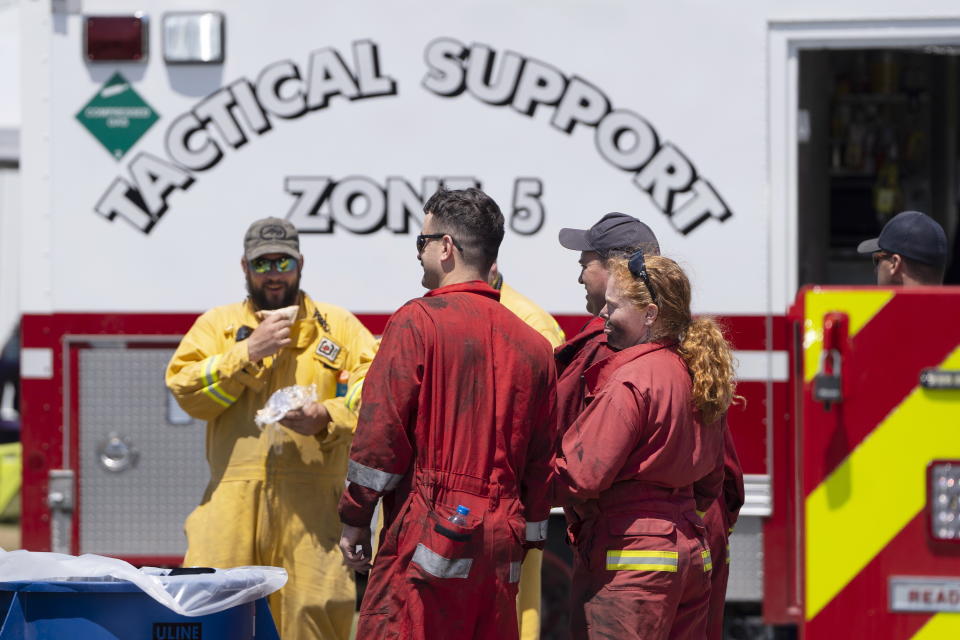 Firefighters arrive at a command center within the evacuated zone of the wildfire burning in Tantallon, Nova Scotia, outside of Halifax on Wednesday, May 31, 2023. (Darren Calabrese/The Canadian Press via AP)