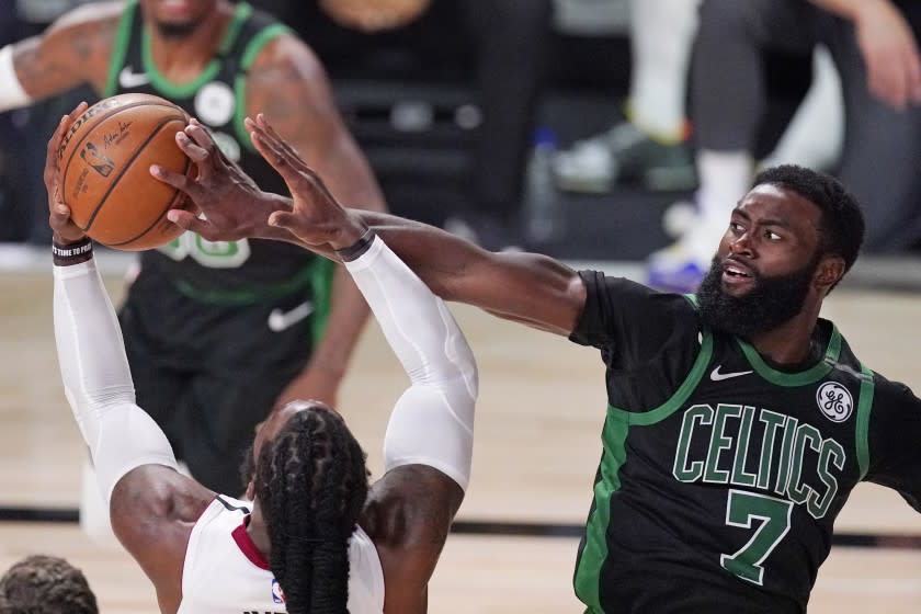 Boston Celtics' Jaylen Brown (7) and Miami Heat's Jae Crowder battle during the second half.