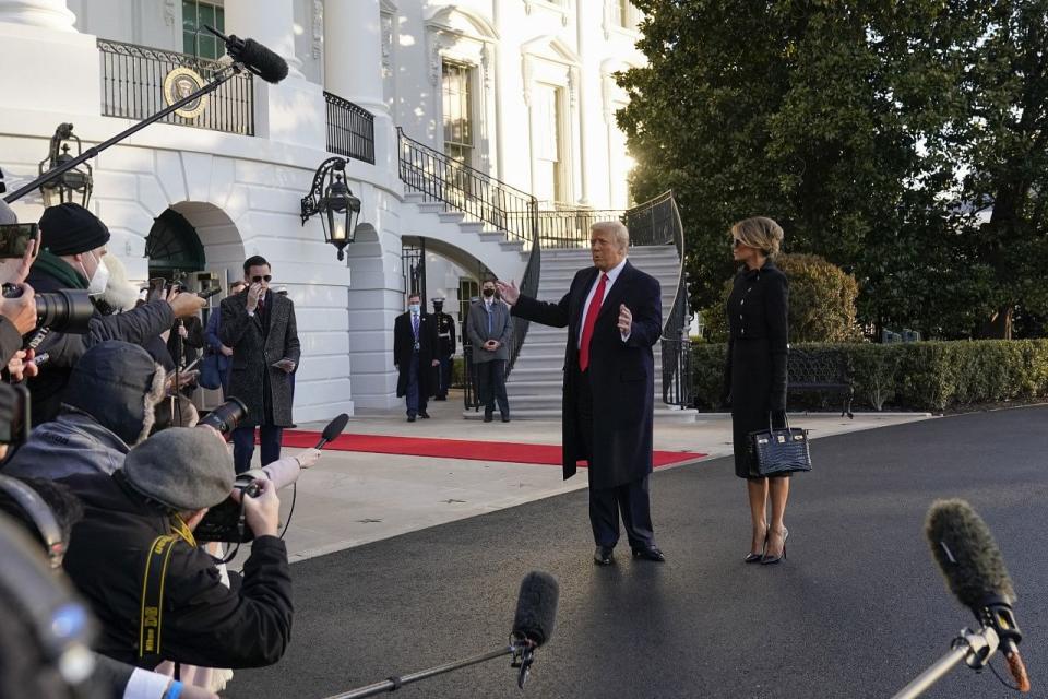 President Donald Trump and first lady Melania Trump stop to talk with the media as they walk to board Marine One on the South Lawn of the White House.