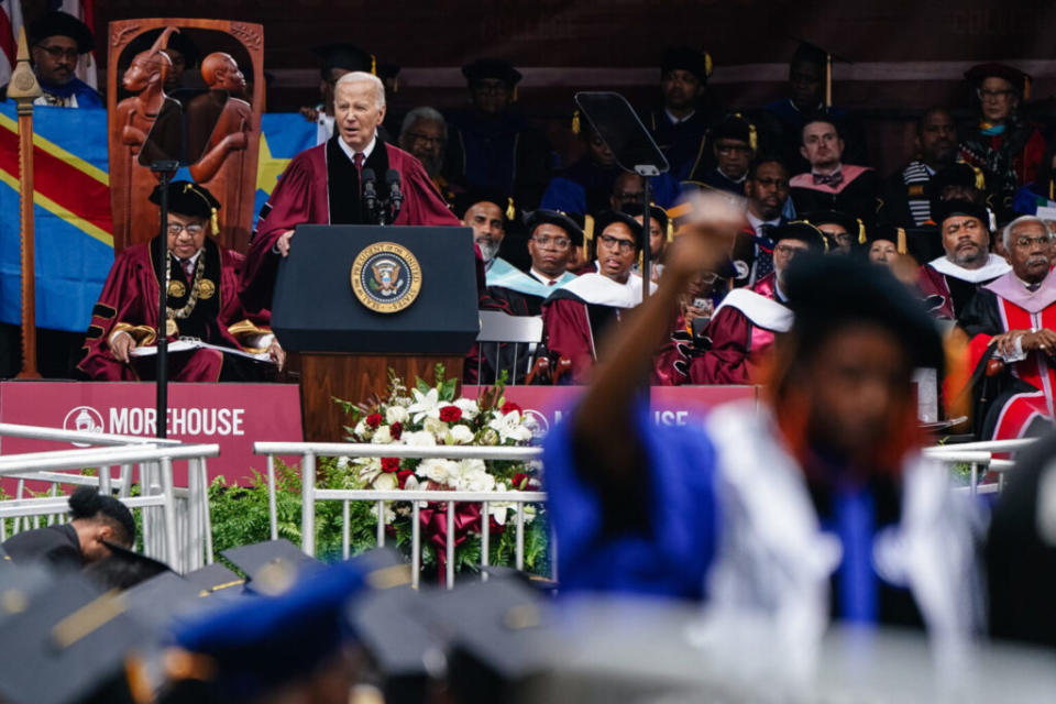 Joe Biden speaking with a blurry man with his back turned toward him