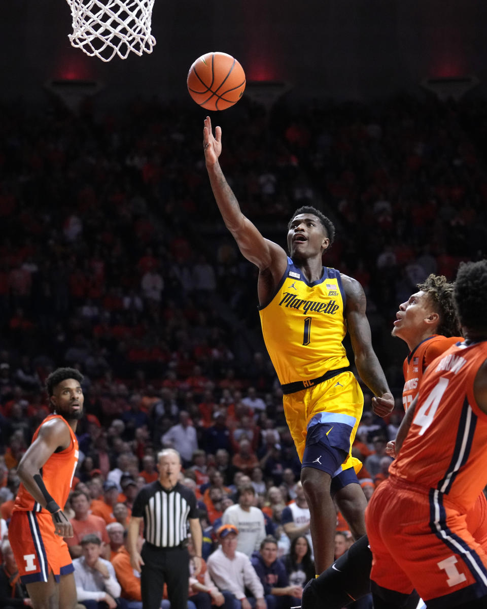 Marquette guard Kam Jones scores past Illinois forward Coleman Hawkins during the second half of an NCAA college basketball game Tuesday, Nov. 14, 2023, in Champaign, Ill. (AP Photo/Charles Rex Arbogast)