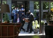 Kazakh law enforcement officers detain a man during an opposition rally in Almaty