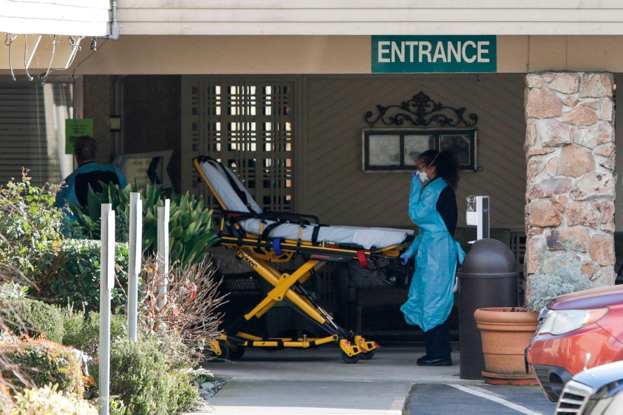 Health specialists at the Life Care Center in Kirkland, Washington, where a resident and an employee were confirmed as having the coronavirus: AFP via Getty Images