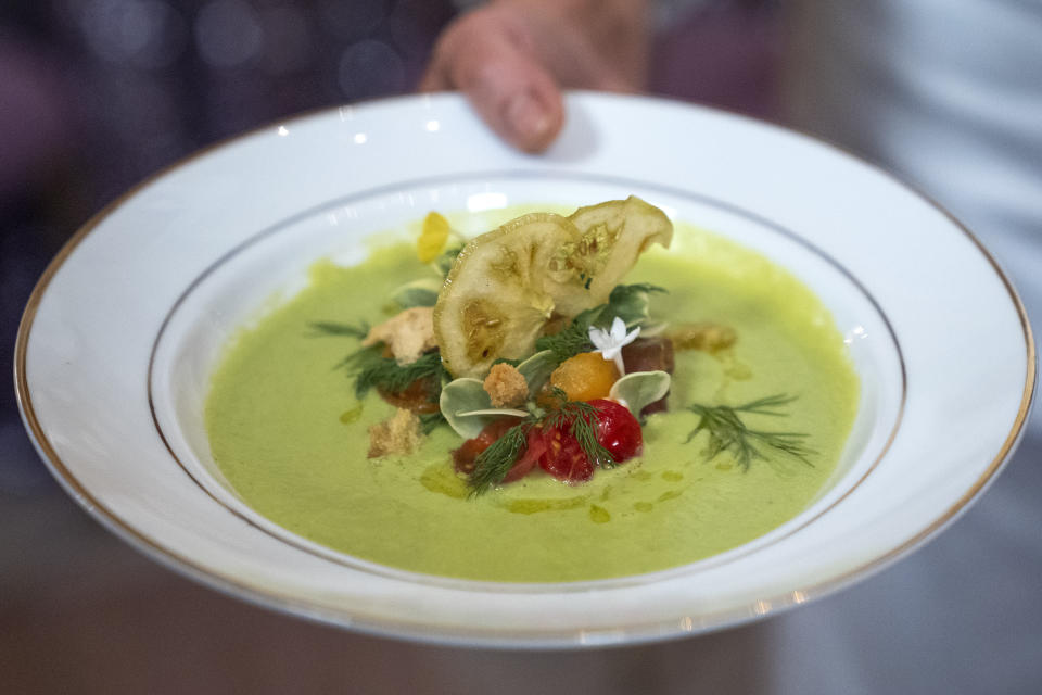 The first course, a chilled heirloom tomato soup with sourdough crisps and arbequina olive oil is shown by White House Executive Chef Cris Comerford during a media preview, Wednesday, May 22, 2024, ahead of Thursday evening's State Dinner with Kenya's President William Ruto, at the White House in Washington. (AP Photo/Jacquelyn Martin)