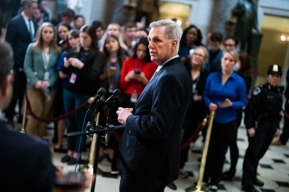 Speaker Kevin McCarthy stands at a set of microphones at a news conference.