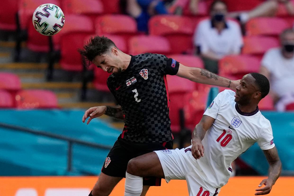 Croatia's defender Sime Vrsaljko (L) challenges for the ball with Raheem Sterling.