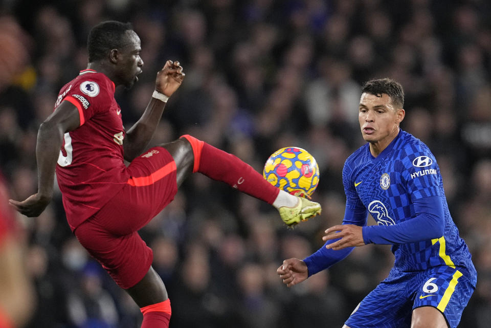 Liverpool's Sadio Mane, left, and Chelsea's Thiago Silva contest possession during the English Premier League soccer match between Chelsea and Liverpool at Stamford Bridge in London, Sunday, Jan. 2, 2022. (AP Photo/Matt Dunham)