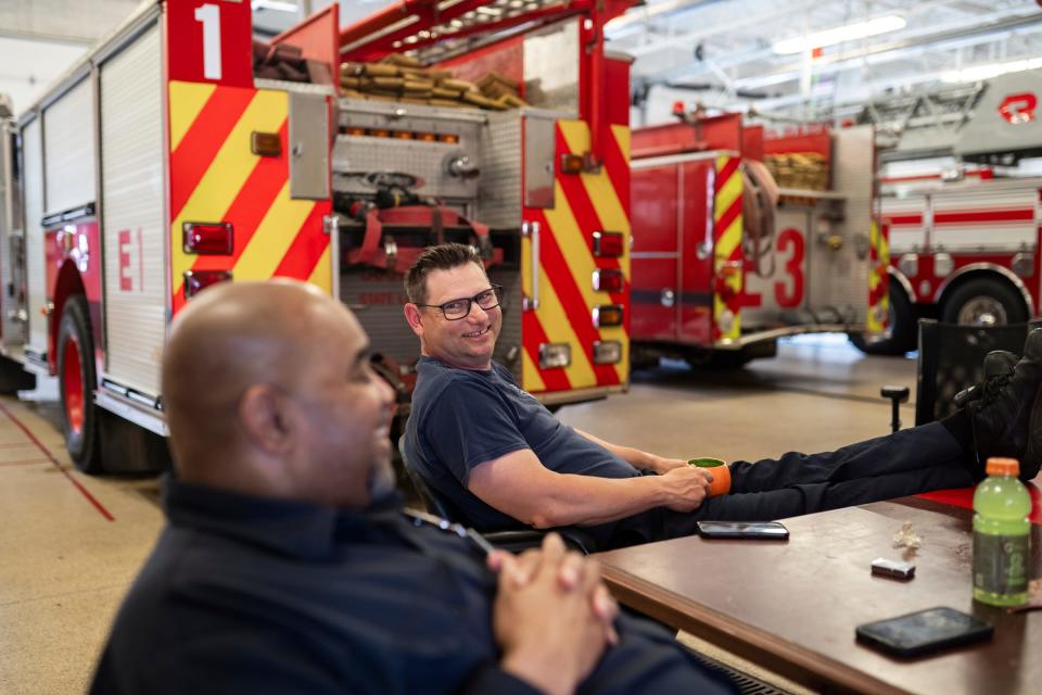 Highland Park Firefighters Charles Minard Jr., left, and Marcus Pasquinelli talk during downtime at the Highland Park Fire Department on Fri., May 3, 2024.