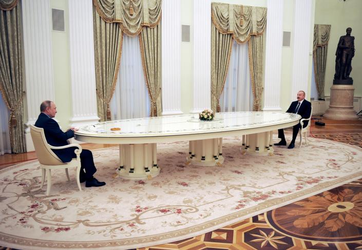 Russian President Vladimir Putin, left, speaks to Azerbaijani President Ilham Aliyev during their meeting in the Kremlin in Moscow, Russia, Tuesday, Feb. 22, 2022. (Sputnik, Kremlin Pool Photo via AP)