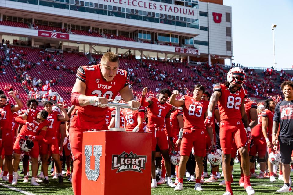 Utah Utes linebacker Lander Barton (20) lights the U after their victory over the Weber State Wildcats at Rice-Eccles Stadium in Salt Lake City on Saturday, Sept. 16, 2023. The Utah Utes won the game with a final score of 31-7.