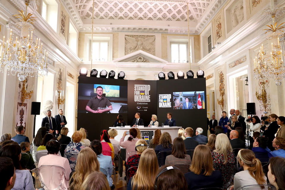 WARSAW, POLAND - APRIL 09: (L-R) A message from Ukrainian President Volodymyr Zelensky is played as Isha Sesay, Andrzej Duda, President of the Republic of Poland, Ursula von der Leyen, President of the European Commission, Hugh Evans, CEO & Co-founder, Global Citizen, and Justin Trudeau, Prime Minister of Canada (on screen) speak onstage during Stand Up For Ukraine on April 09, 2022 in Warsaw, Poland. (Photo by Brian Dowling/Getty Images for Global Citizen)