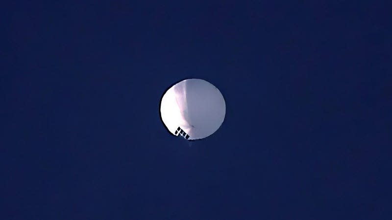 A photo of a white spy balloon in the sky over Montana.