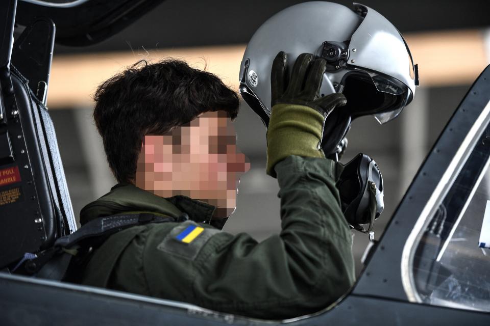 A Ukrainian trainee puts on his helmet ahead of a flight with an unseen French military instructor onboard an Alpha Jet fighter jet, at a French Army air base in south-western France (AFP via Getty Images)