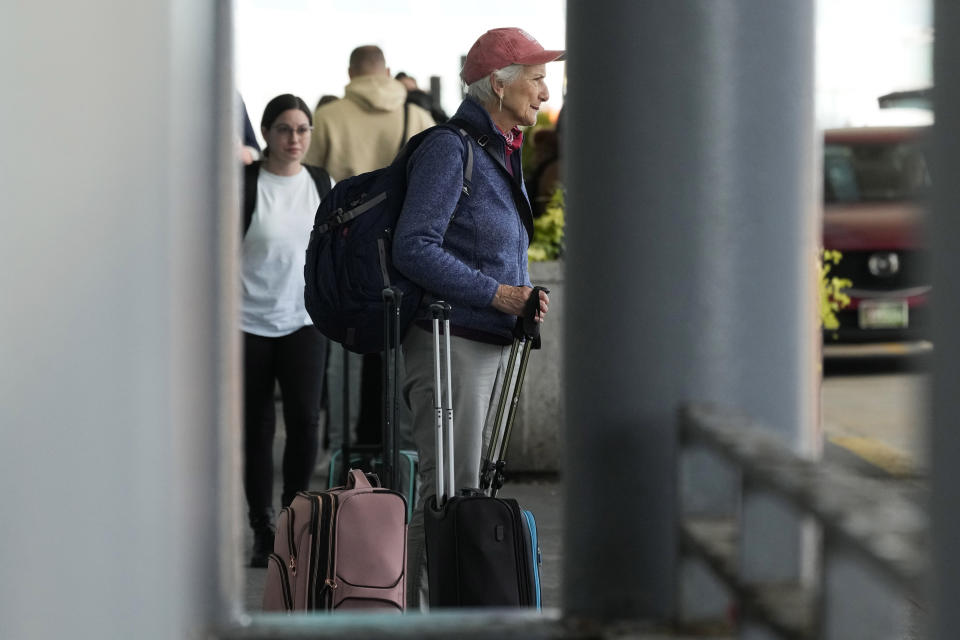 Travelers wait for their ride at O'Hare International Airport in Chicago, Monday, April 15, 2024. Pro-Palestinian demonstrators blocked a freeway leading to three Chicago O'Hare International Airport terminals Monday morning, temporarily stopping vehicle traffic into one of the nation's busiest airports and causing headaches for travelers. (AP Photo/Nam Y. Huh)