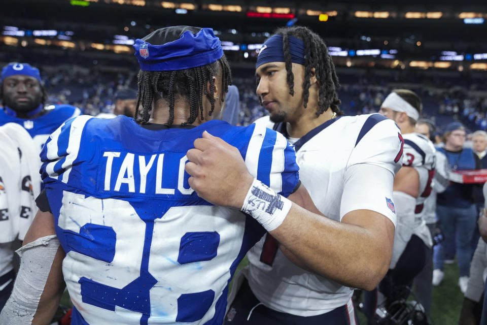 Houston Texans quarterback C.J. Stroud, right, hugs Indianapolis Colts running back Jonathan Taylor (28) after an NFL football game Saturday, Jan. 6, 2024, in Indianapolis. (AP Photo/Michael Conroy)