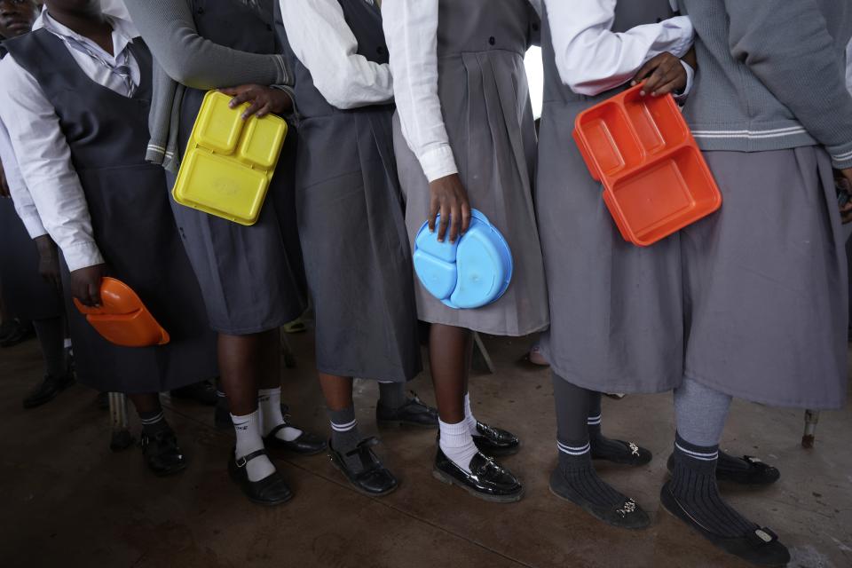 Girls join a lunch queue at Chileshe Chepela Special School in Kasama, Zambia, Thursday, March 7, 2024. Many students are deaf or hard of hearing. (AP Photo/Tsvangirayi Mukwazhi)
