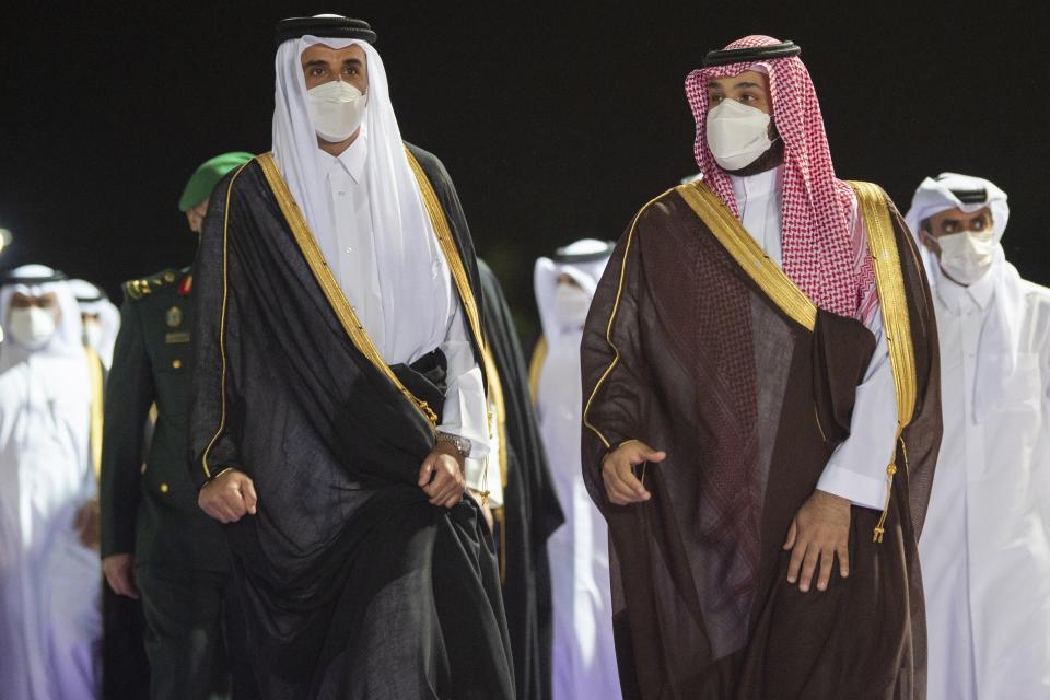 FILE - In this photo released by Saudi Royal Palace, Saudi Crown Prince Mohammed bin Salman, right, accompanies Qatar's Emir Sheikh Tamim bin Hamad Al Thani upon his arrival at in the Red Sea city of Jiddah, Saudi Arabia, Monday, May 10, 2021. For decades, Doha has flung open its doors to Taliban warlords, Islamist dissidents, African rebel commanders and exiles of every stripe. (Bandar Aljaloud/Saudi Royal Palace via AP, File)