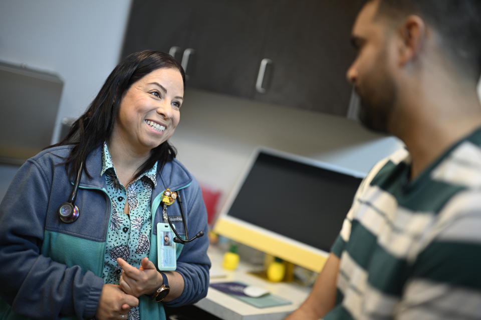 Nurse practitioner Eliza Otero, left, talks with Fernando Hermida at Pineapple Healthcare in Orlando, Fla., on May 28, 2024. (AP Photo/Phelan M. Ebenhack)