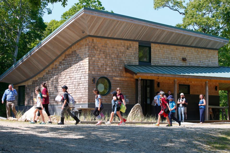 Students visiting the Lloyd Center for the Environment in Dartmouth walk past the new carbon neutral Living Building Challenge building.