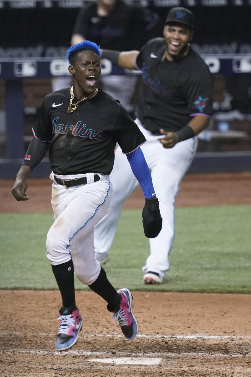 Miami Marlins' Jazz Chisholm Jr. (2) crosses home plate on a double by Jorge Alfaro for the winning run in the 10th inning against the San Francisco Giants in a baseball game Saturday, April 17, 2021, in Miami. The Marlins won 7-6. (AP Photo/Marta Lavandier)