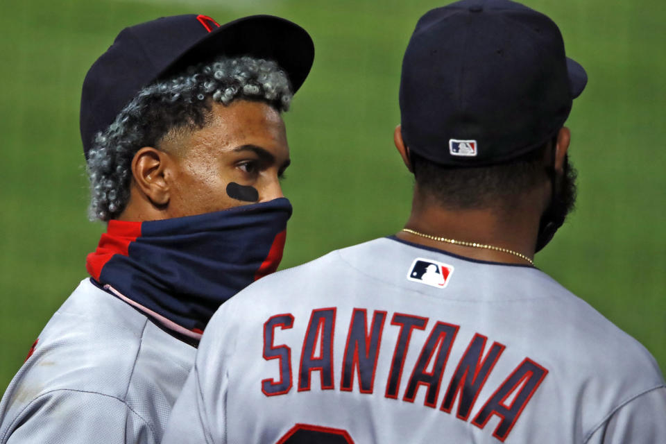Cleveland Indians' Francisco Lindor, left, talks with Carlos Santana before taking the field for the eighth inning of a baseball game against the Pittsburgh Pirates in Pittsburgh, Thursday, Aug. 20, 2020. (AP Photo/Gene J. Puskar)