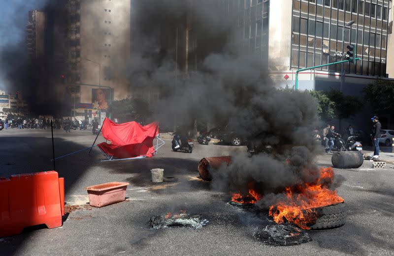 Demonstrators block a road during a protest in Beirut