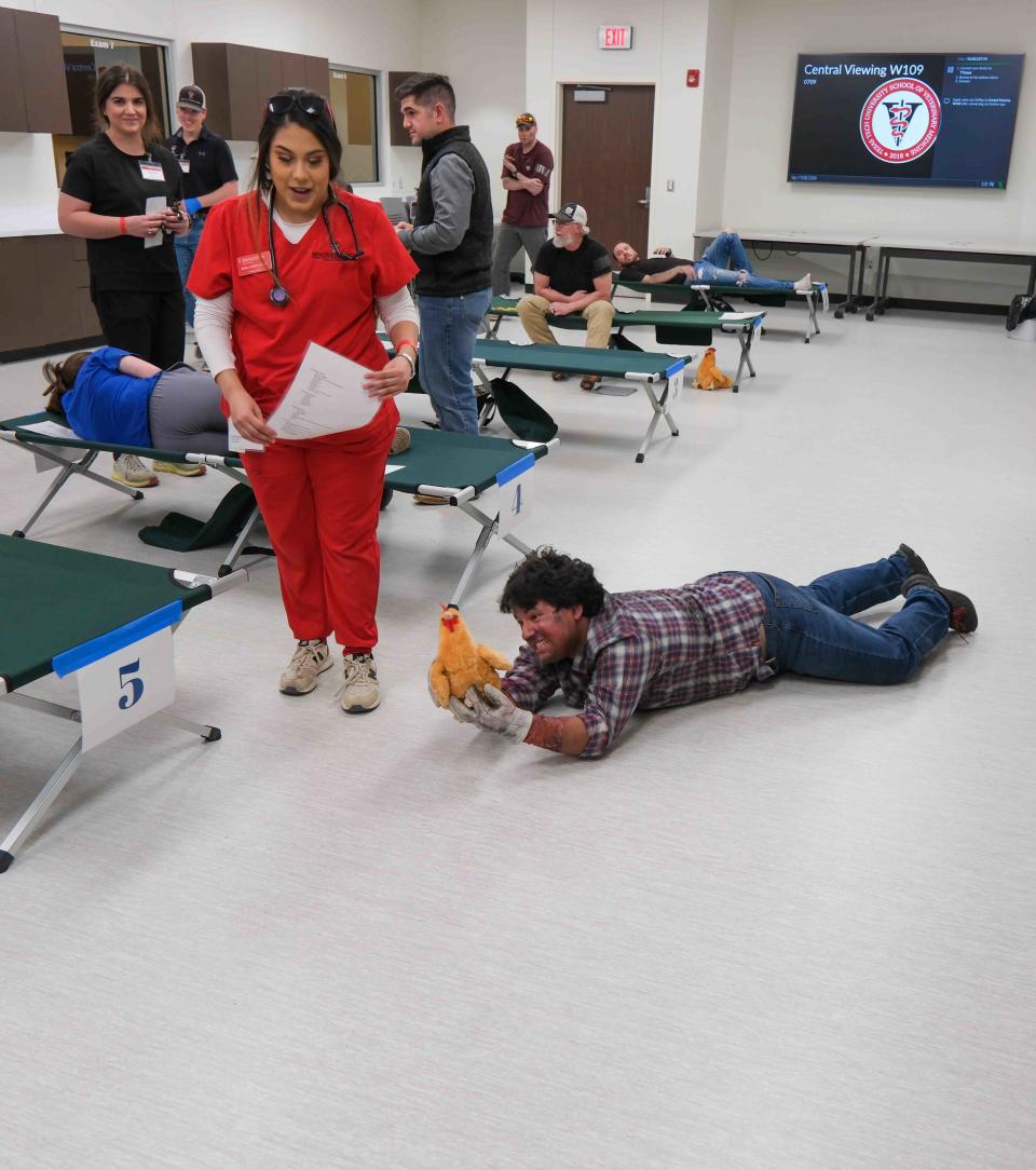 A nursing student looks on as a scenario involving a man and his chicken plays out Friday during a mass disaster simulation at the Texas Tech University Health Sciences  Center in Amarillo.