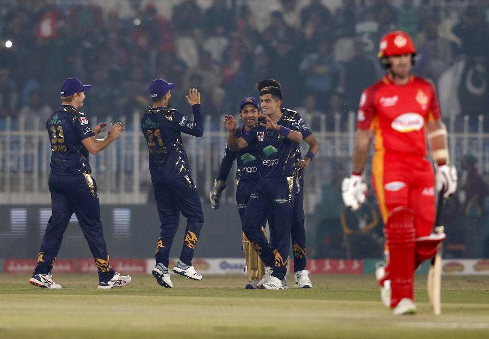 Quetta Gladiators pacer Naseem Shah, center, celebrates with teammates after taking the wicket of Islamabad United batsman Luke Ronchi, right, during a Pakistan Super League T20 cricket match at Rawalpindi Stadium, in Rawalpindi, Pakistan, Thursday, Feb. 27, 2020. (AP Photo/Anjum Naveed)