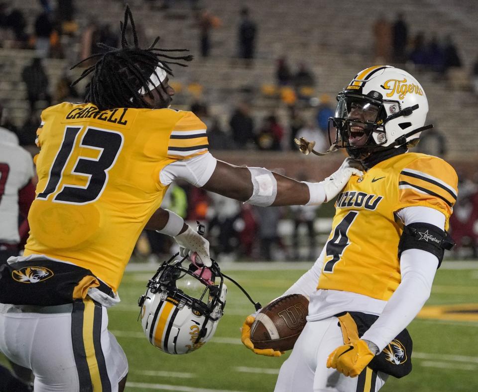 Nov 19, 2022; Columbia, Missouri, USA; Missouri Tigers defensive back Jalani Williams (4) celebrates with defensive back Daylan Carnell (13) after William’s interception against the New Mexico State Aggies during the second half at Faurot Field at Memorial Stadium.