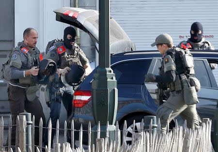 Police at the scene where shots were fired during a police search of a house in the suburb of Forest near Brussels, Belgium, March 15, 2016. REUTERS/Francois Lenoir